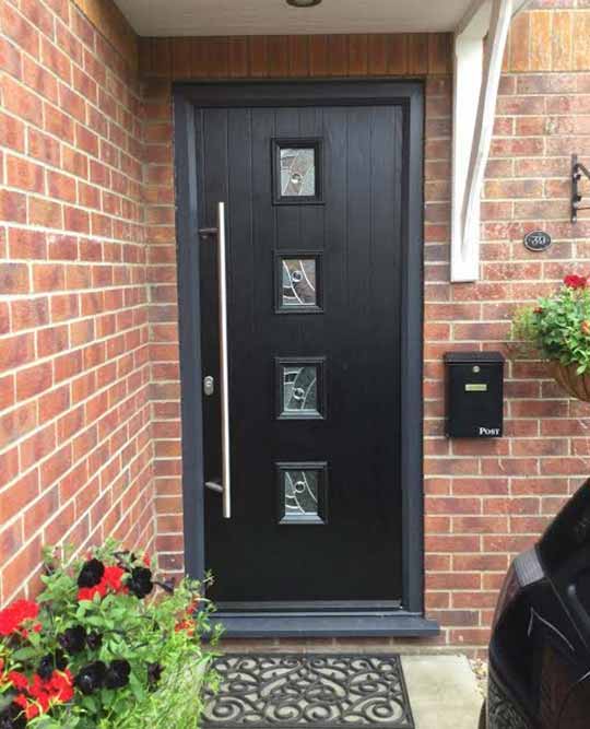 modern composite style black front door with a long bar handle