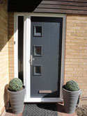 grey front door with glass side panel